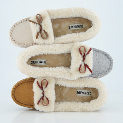 Three pairs of fluffy slippers with brand name on a light gray background